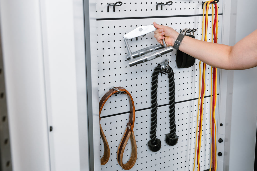 Image of someone taking off an attachment from the white pegboard on the white version of the Arcadia™ max