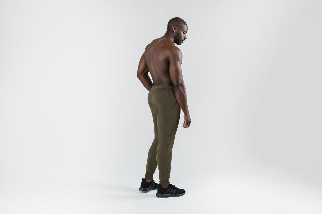 The REP Fitness Men's Attis Joggers in Heather Olive back, looking over shoulder