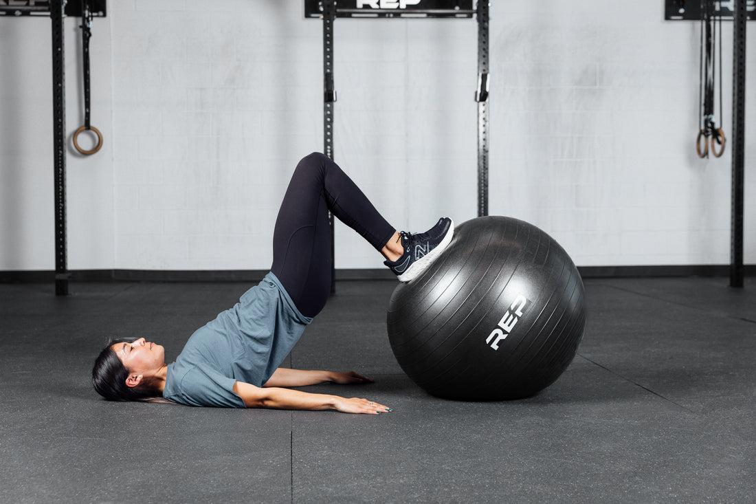 An athlete doing hamstring curls with the REP Physioball.