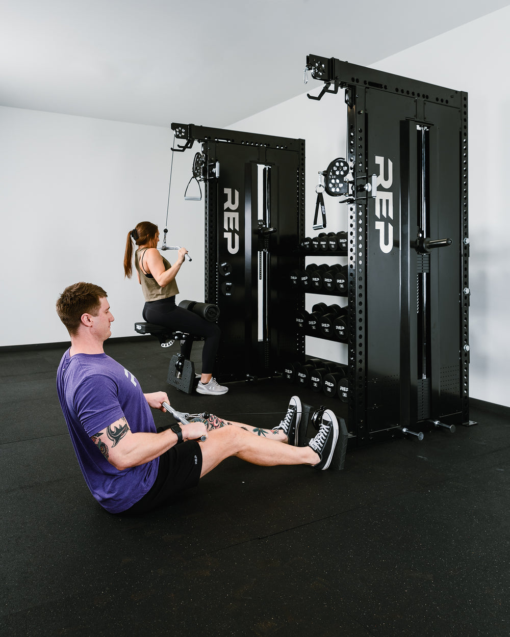 2 people training on a Dual Adonis™ with Storage setup. One is doing lat pulldowns on one side while the other is doing low rows on the other.