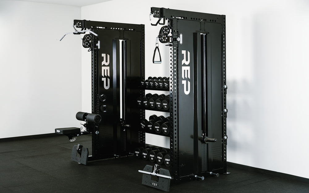 Dual Adonis™ Cable Towers with 72" storage shelves holding a set of 5-100 Dumbbells