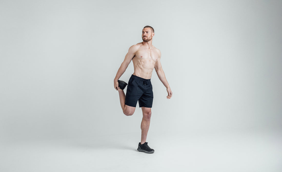The REP Fitness Men's Apollo Shorts in Heather Navy/Cool Gray front, stretching