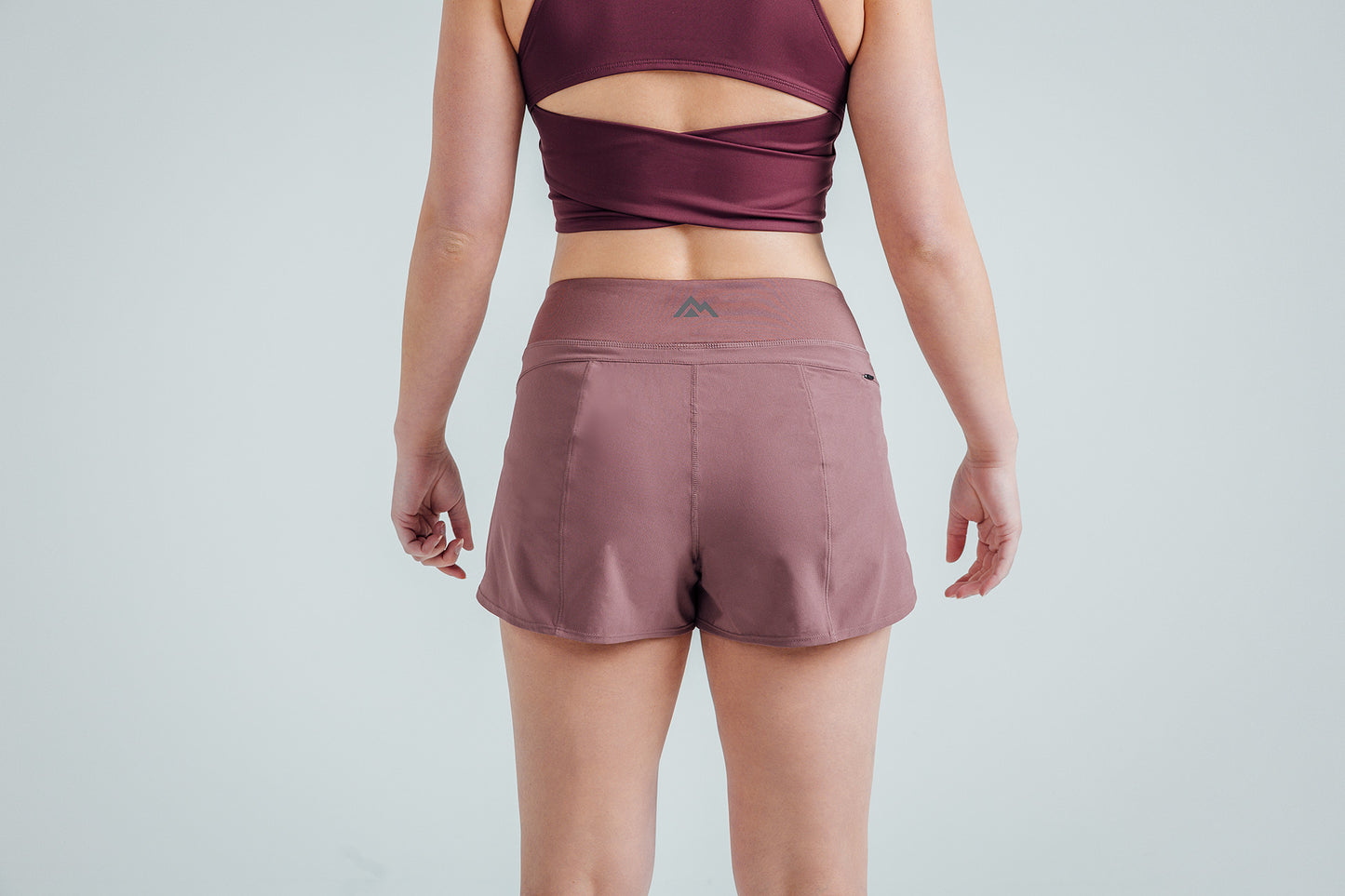 Back shot: Athlete wearing the Mauve Women’s Artemis Shorts on a white background