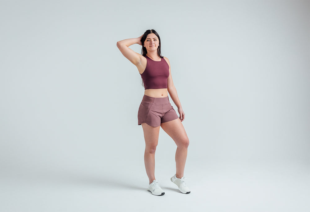 Full body shot: Athlete striking a pose in the Mauve Women’s Artemis Shorts