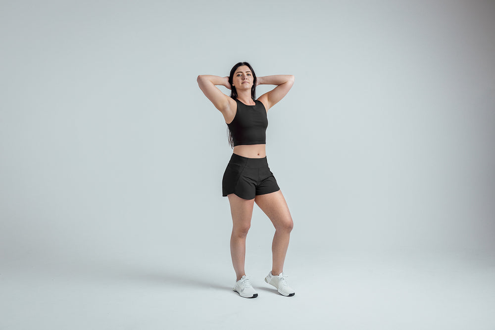 Full body shot: Athlete striking a pose in the Black Women’s Artemis Shorts
