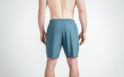 Athlete wearing Slate Men's Motus Shorts, back view