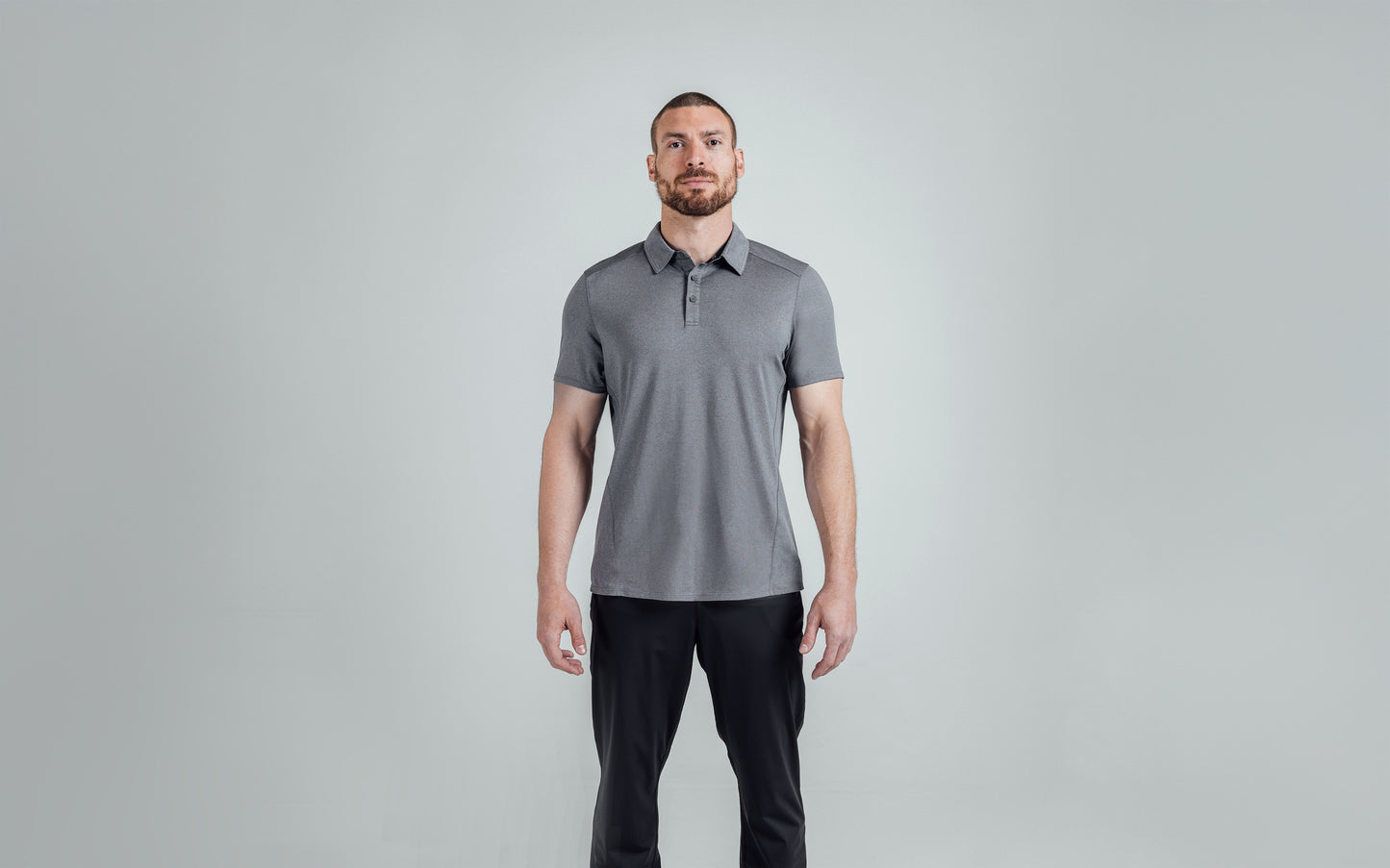 A front shot of an athlete wearing the REP Audax Polo in 
Heather Cool Gray