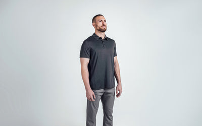 A 3/4 shot of an athlete wearing the REP Audax Polo in 
Heather Black