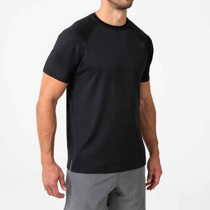 Person wearing a black Men's Aerix athletic shirt and shorts on a white background