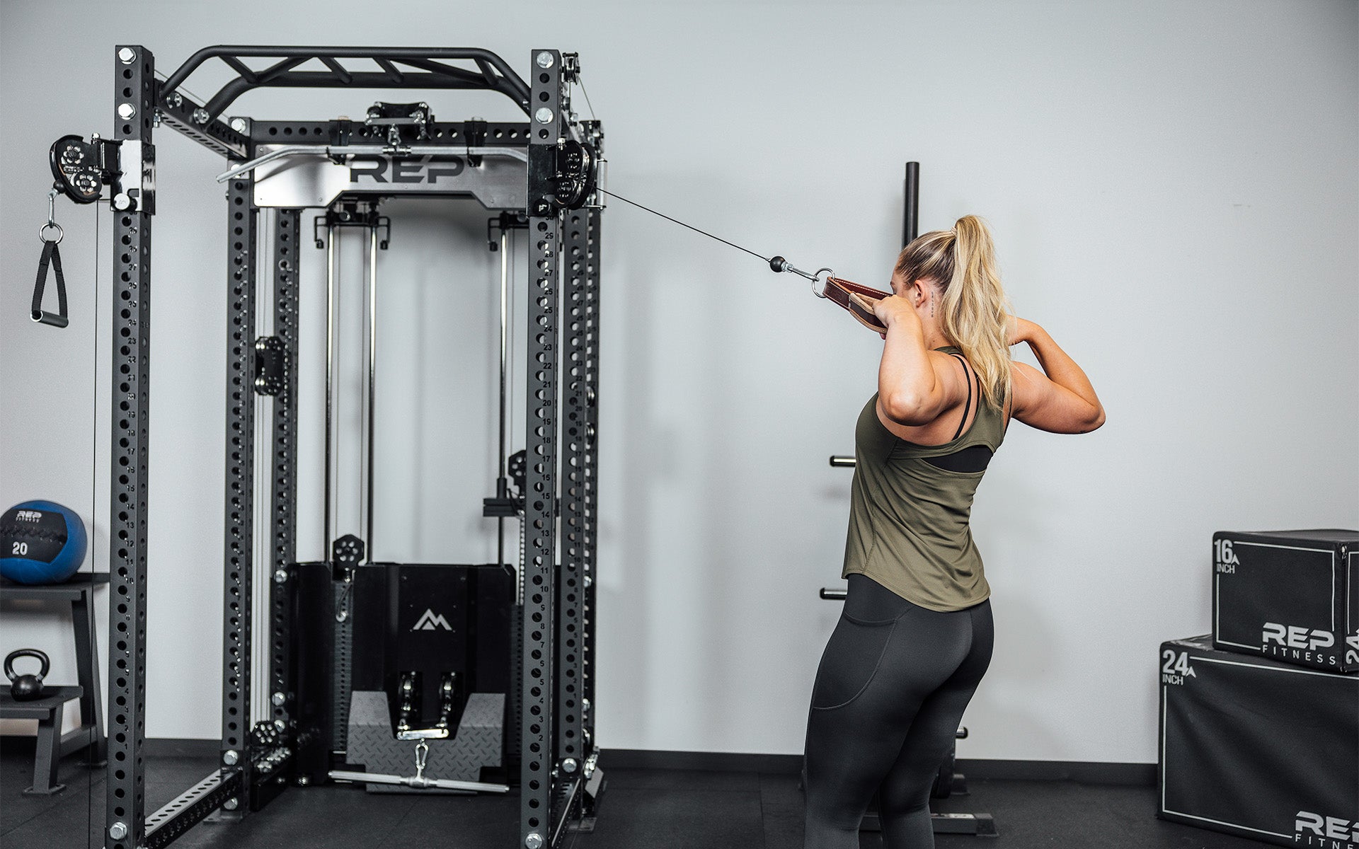 Woman doing face pulls using the Ares 2.0 and the REP USA Leather Accessory Strap