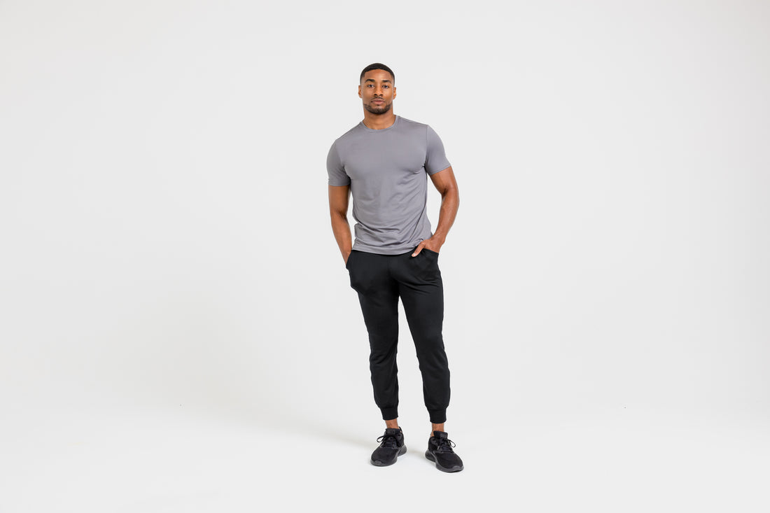 The REP Fitness Men's Attis Joggers in Heather Black front, with gray tee