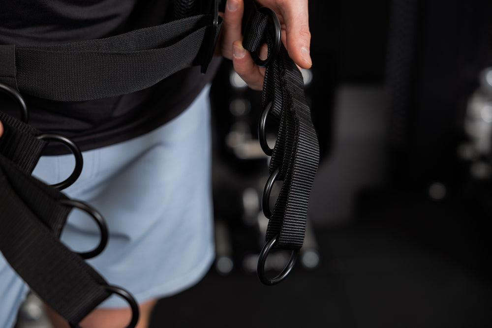 Person wearing the belt squat belt showing the o-rings for different length options