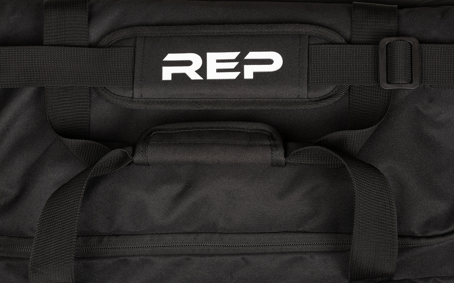 Black shoulder strap with white REP logo on the pad, along with black carrying handles