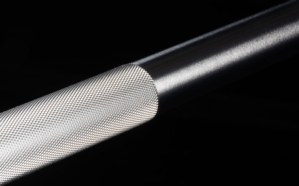 Close-up view of where the volcano center knurling meets the smooth shaft on the REP 15kg Colorado Bar.