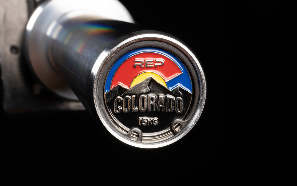 Close-up view of the uniquely designed metal endcap of a racked REP 15kg Colorado Bar.