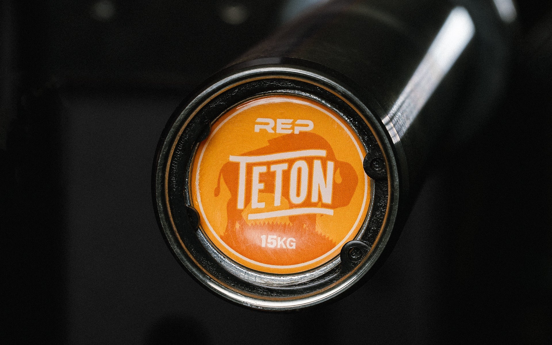 Close-up view of the barbell endcap on the REP 15kg Teton Training Bar.