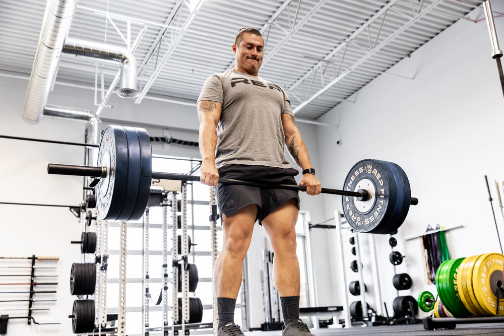 Lifter performing a deadlift using a Black Diamond Power Bar.