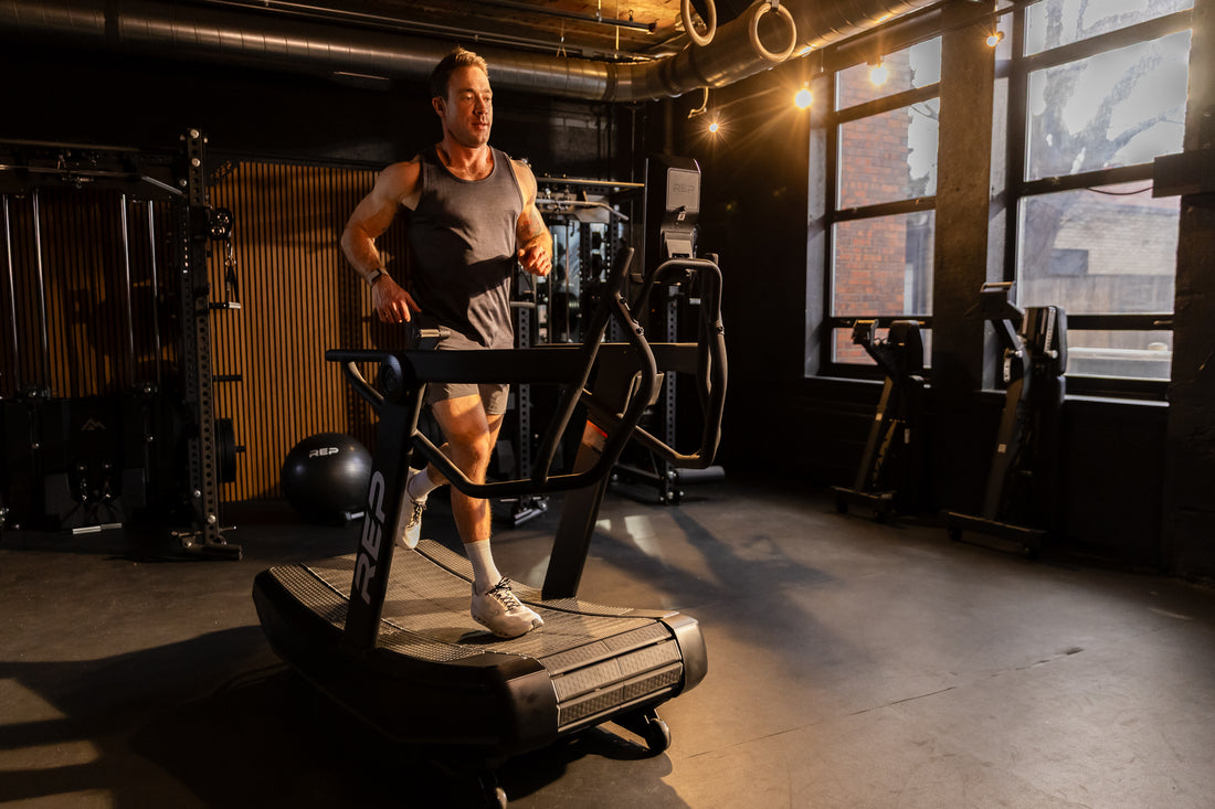 Athlete jogging in run mode on the REP Fitness Strive Curved Treadmill