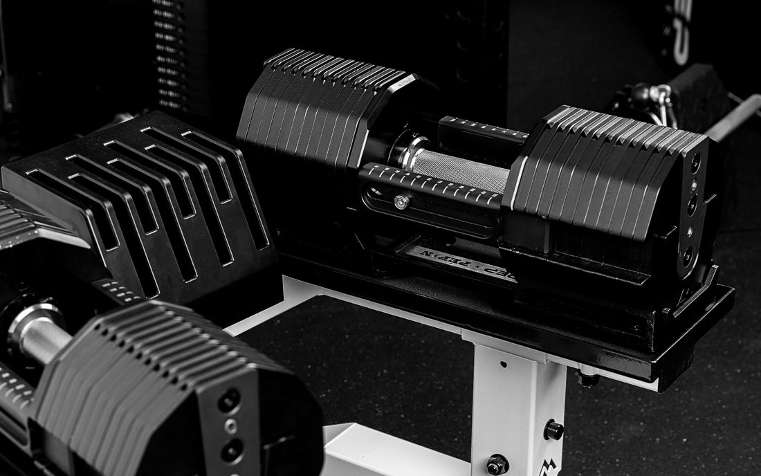 REP x PÉPIN FAST Series Adjustable Dumbbells sitting on the REP Adjustable Dumbbell Stand.