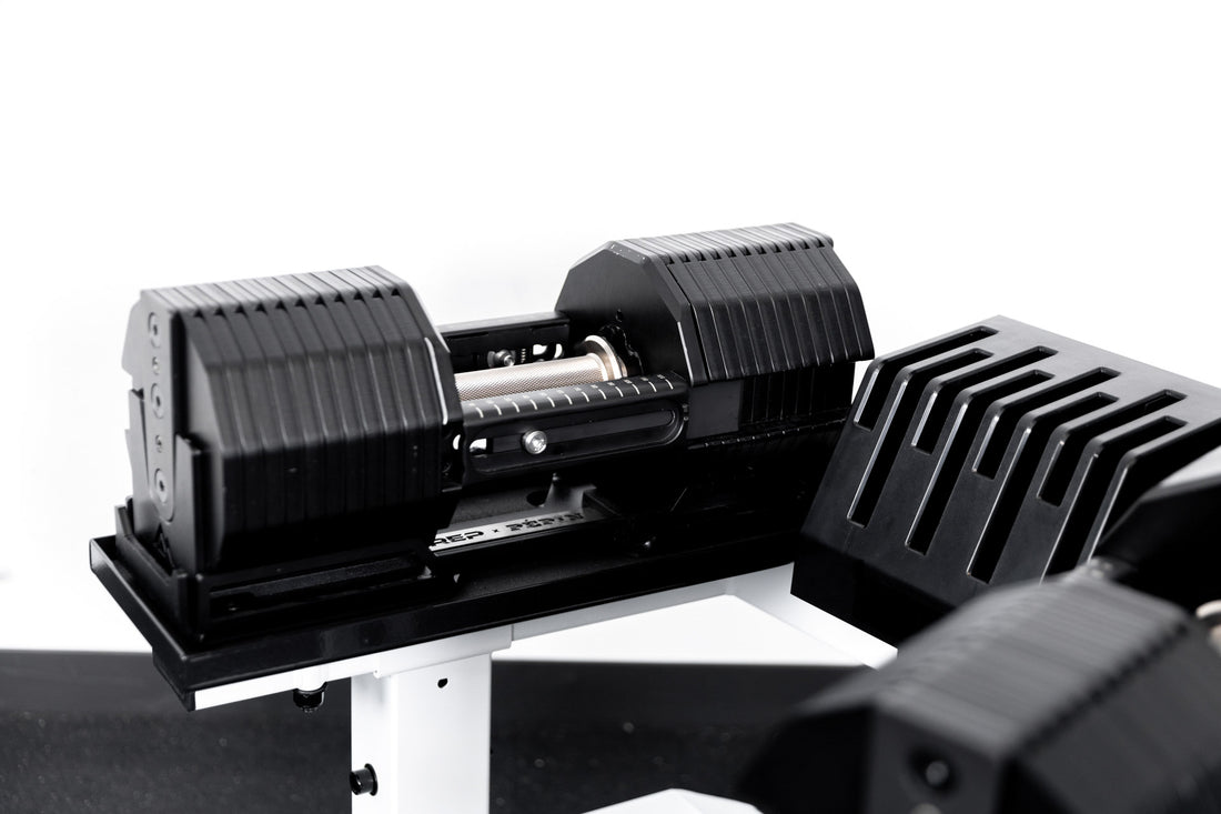 REP® x PÉPIN™ adjustable dumbbells on  a white REP® Adjustable Dumbbell Stand