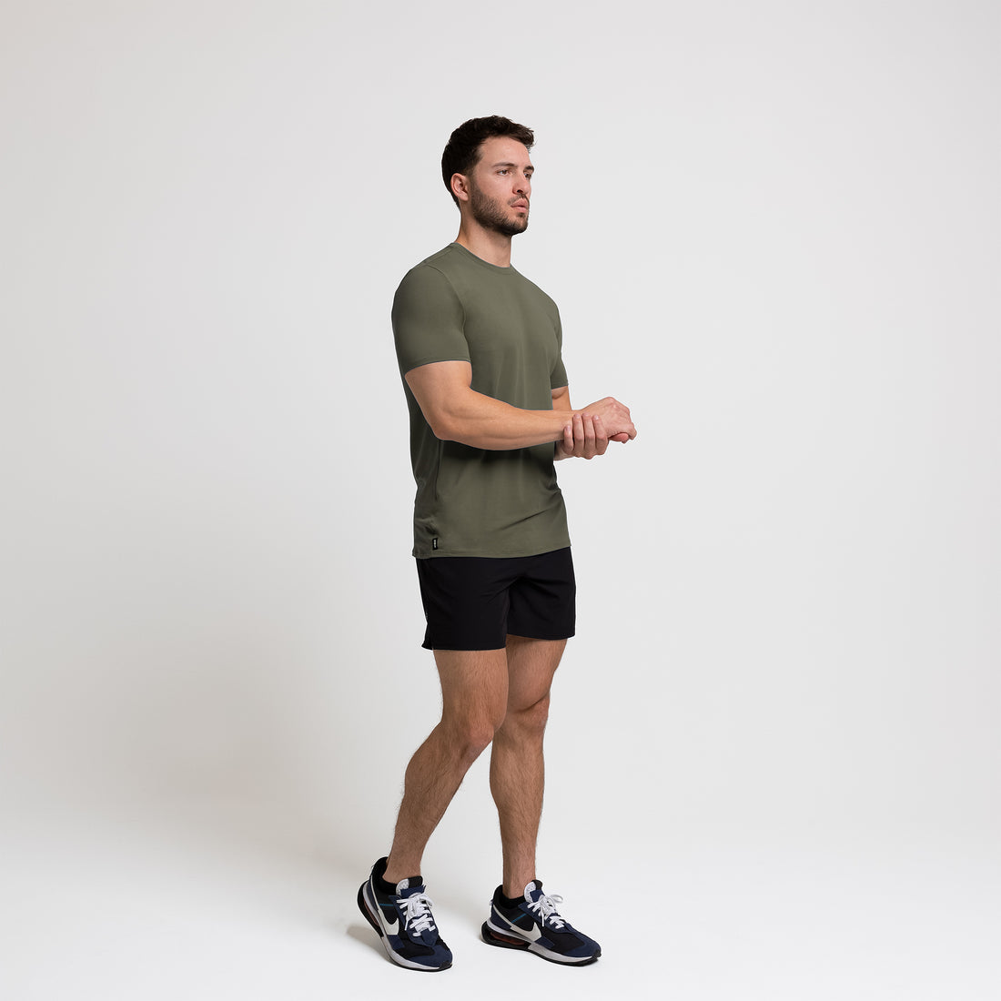 The REP Fitness Men's Delta Shirt in Olive front, side-profile walking