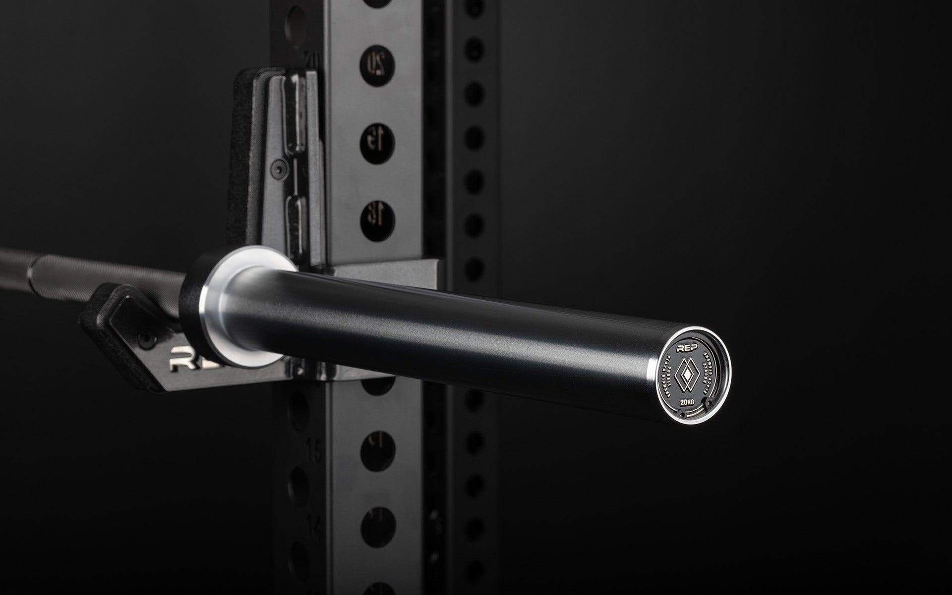 Close-up view of the sleeve and premium endcap of a racked REP Double Black Diamond Power Bar.