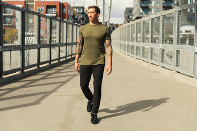 Athlete walking in the city wearing the black Men's Felix Pants 2.0