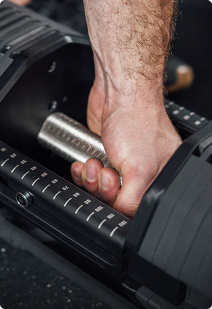 Dumbbells - Close Up of someone grabbing a REP® x PEPIN™ Fast Series™ Adjustable Dumbbell 