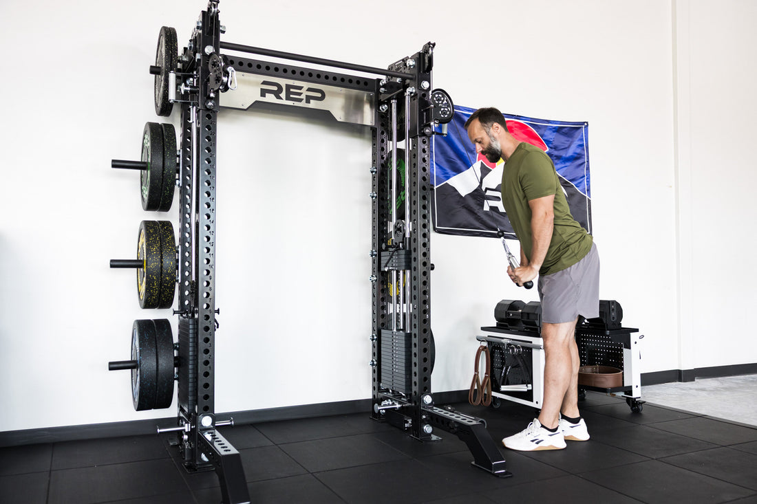 power rack with front foot extension pair 2.0 adding stability to front of rack while someone use cable machine attachment for tricep pushdowns