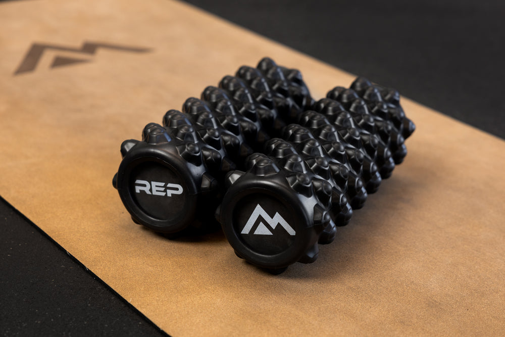 Black "peak" textured High Density Foam Roller with 'REP' and Mountain logos on a cork yoga mat