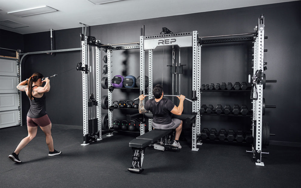 2 Athletes training on the Hyperion series 1. 1 using the left side cable while the other uses the center lat pulldown.