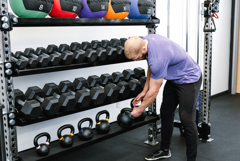 Dumbbell & Kettlebell Storage Shelf holding dumbbells, kettlebells, and medicine balls