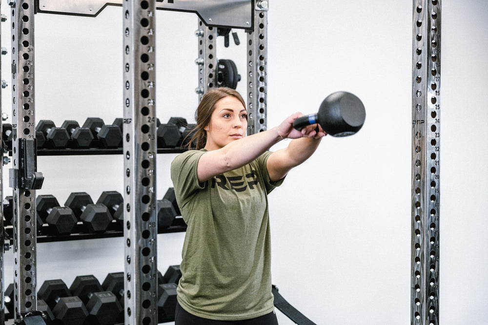 Lifestyle photo of someone working out inside of the rack with the in-rack storage behind