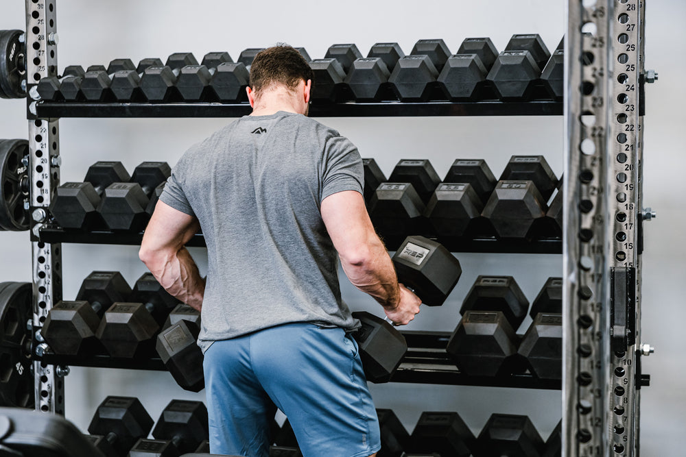 Dumbbell & Kettlebell Storage Shelf holding dumbbells in an off rack configuration