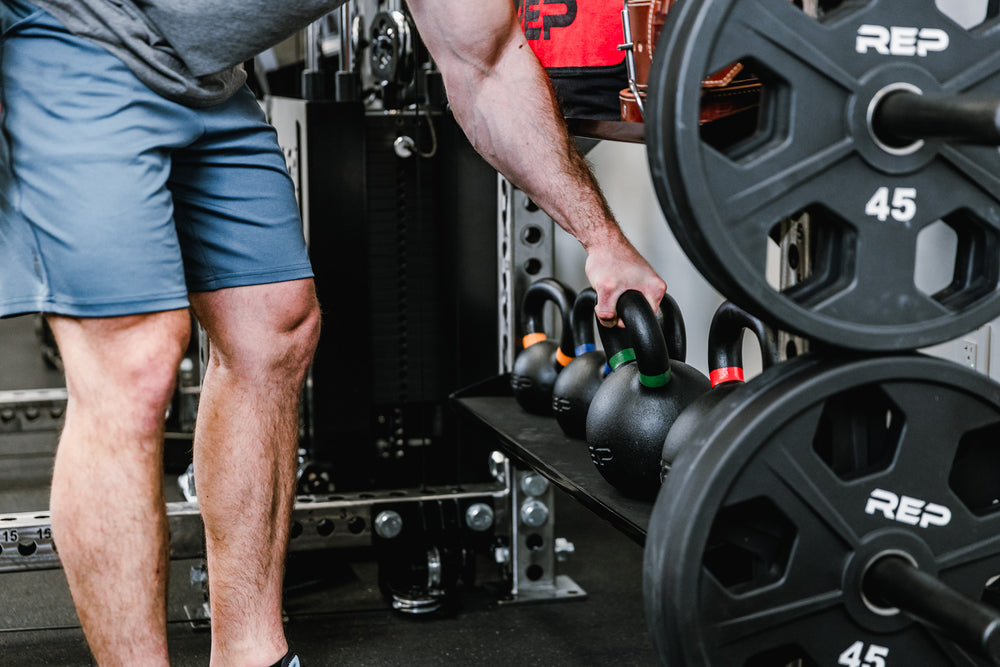 Kettlebell Storage Shelf - Showing REP Kettlebells being stored and someone taking one off