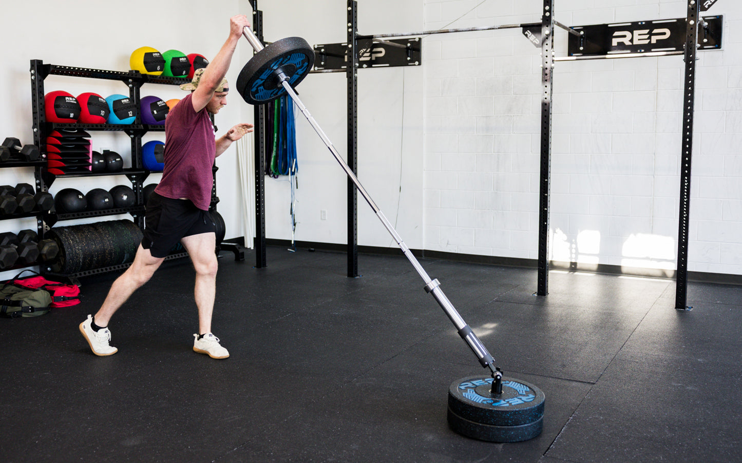 An athlete performing standing presses with the Free Standing REP® x Kleva Built® Adroit Landmine