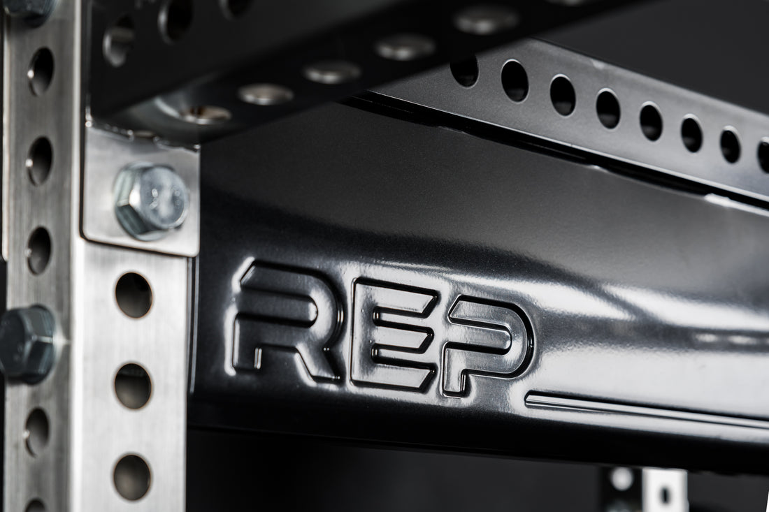 Close-up of metallic black stamped "REP" logo on Logo Plate Crossmember 2.0