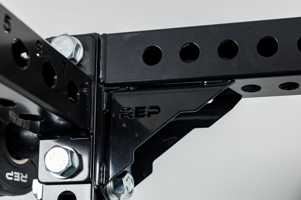 Close-Up of Compact Logo Plate Crossmember 2.0 and the laser-cut "REP" on a REP power rack