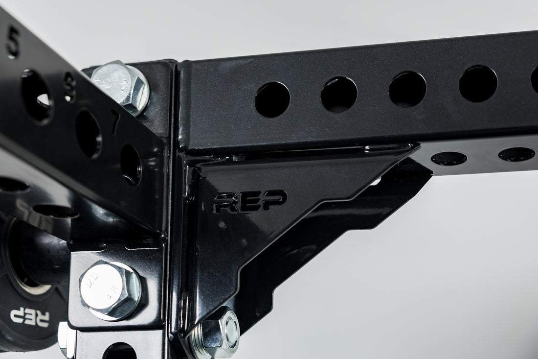 Close-Up of Compact Logo Plate Crossmember 2.0 and the laser-cut "REP" on a REP power rack