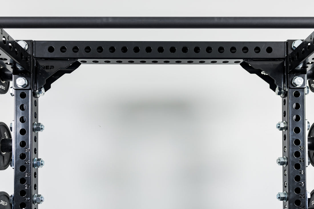 Close-Up of Compact Logo Plate Crossmember 2.0 on a REP power rack