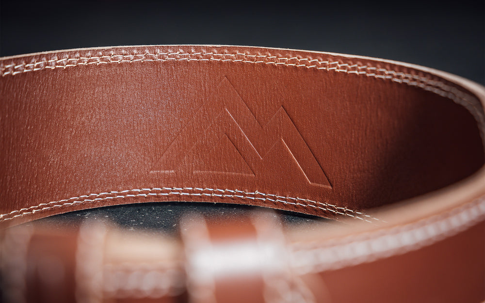 Close-up view of the debossed REP Mountain logo on the inside of the back of the REP Leather Olympic Lifting Belt.