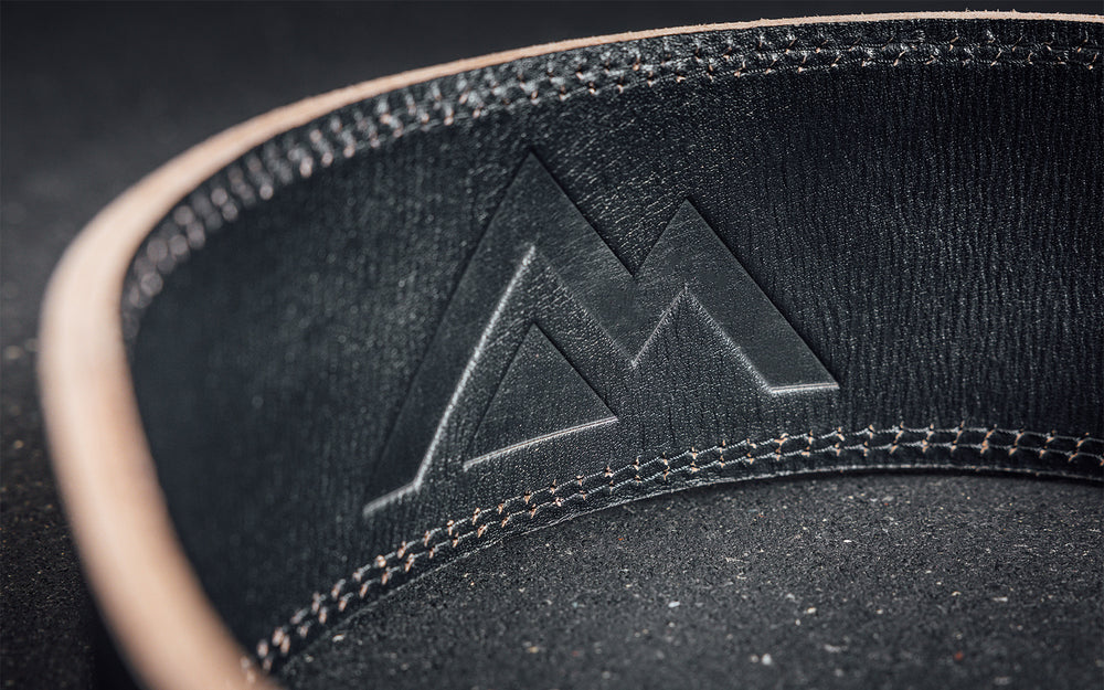 Close-up view of the debossed REP Mountain logo on the back inside part of the black REP Leather Olympic Lifting Belts.