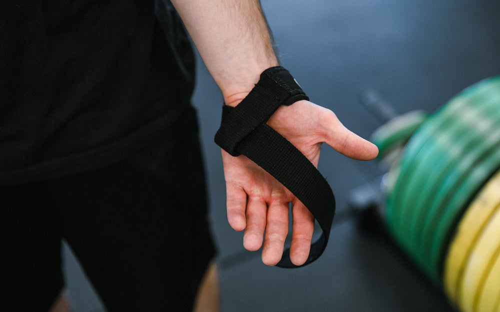 Lifter showing how to wear REP Lifting Straps.