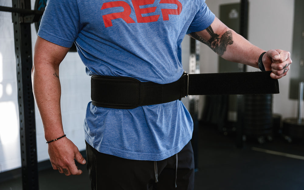 Athlete putting on the REP Nylon Lifting Belt.