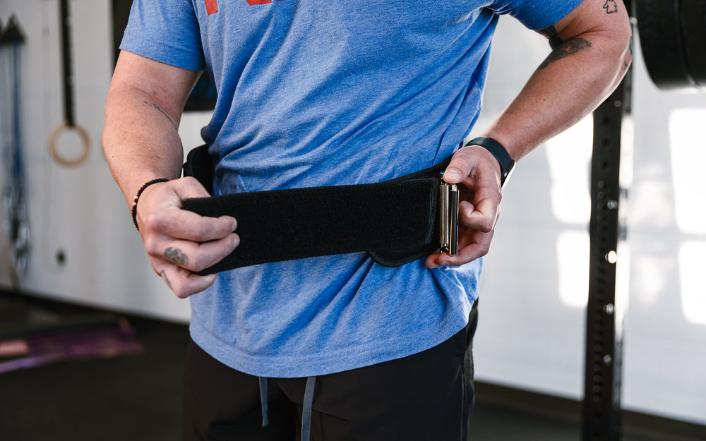 Athlete putting on the REP Nylon Lifting Belt.