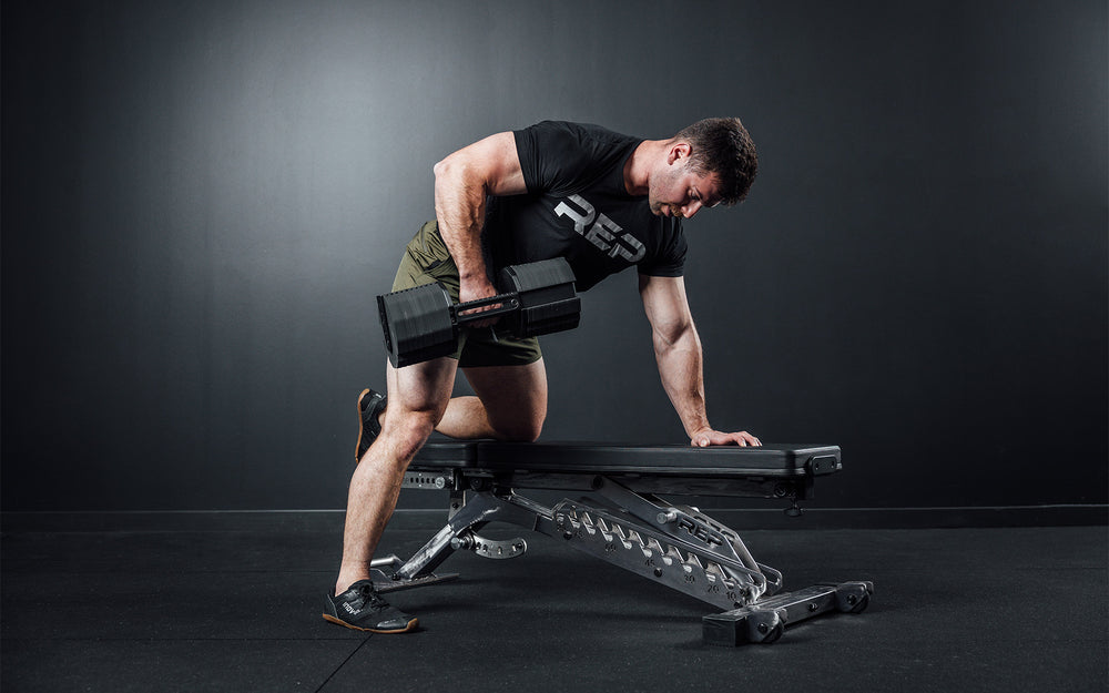 Athlete performing a bent over row with a single REP x PÉPIN FAST Series Adjustable Dumbbell.