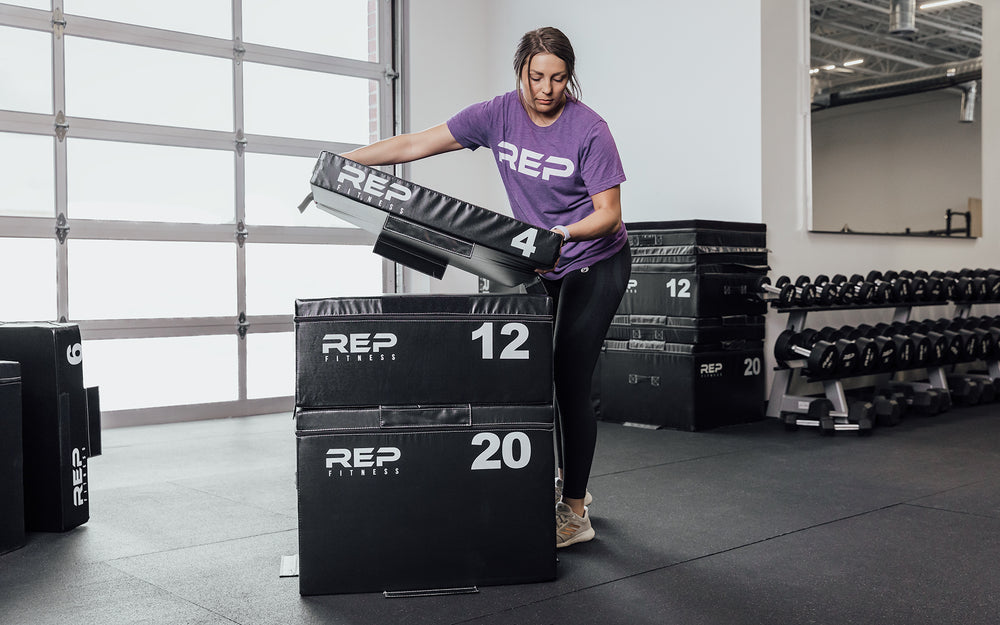 Female athlete adding the 4" REP Stackable Soft Plyo Box to the 20" and 12".