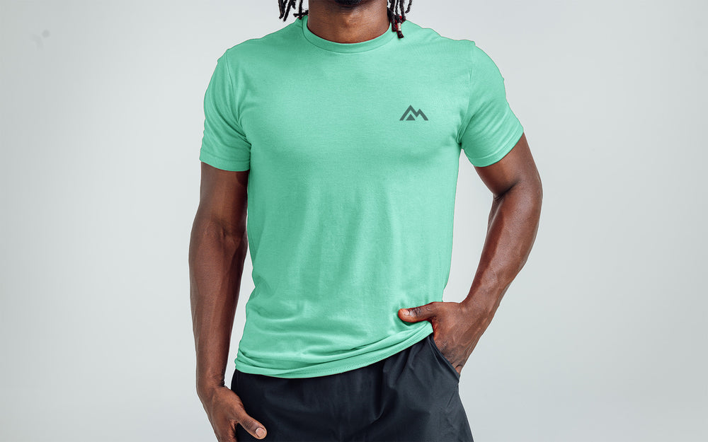 Man wearing Heather Sage/Green Men's Peak Tri-Blend Crew