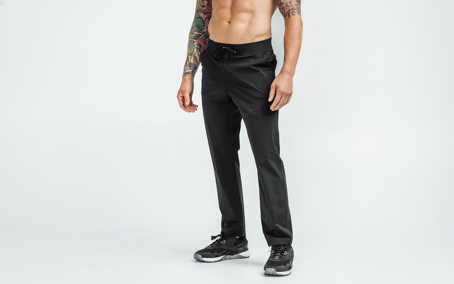 Front view of model wearing the black REP Felix Pants