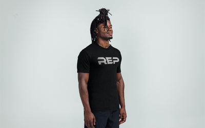 Man wearing Heather Black/White Men's Daily Driver 2.0 Tri-Blend Crew